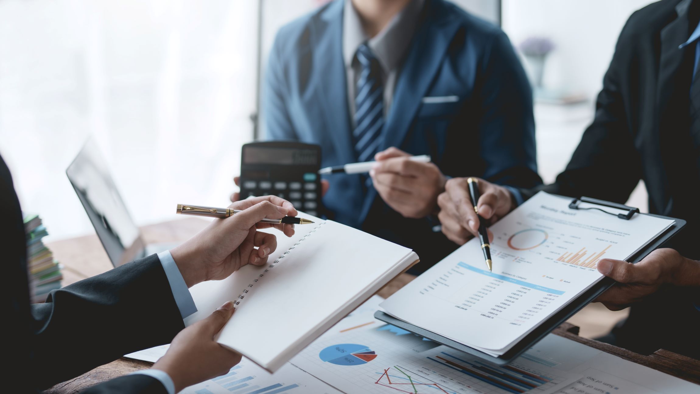 successful-business-team-meeting-pointing-at-graph-2023-11-27-05-36-13-utc